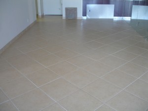 Clean beige tiled floor in an empty room.