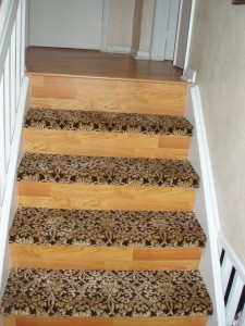 Wooden stairs with leopard print carpet runners on each step.