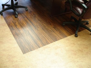 Office floor with wooden and carpeted sections.