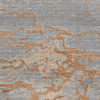 Close-up of textured fabric with gray and rust orange patterns.