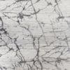 White marble surface with gray and black veining patterns.